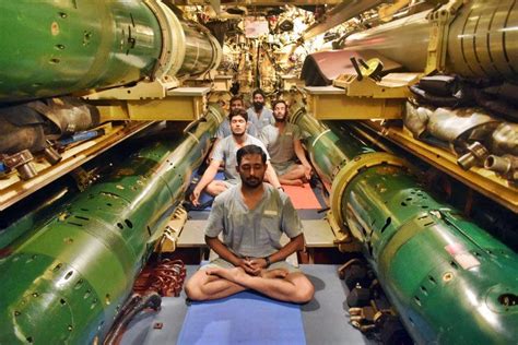 Submariners of Indian Navy doing Yoga inside the torpedo bay of a Kilo-Class submarine ...