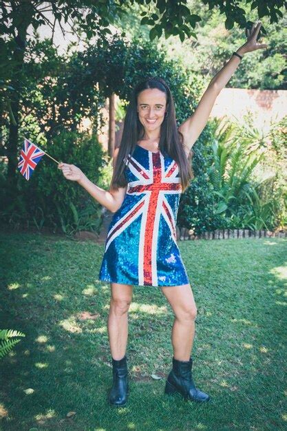 Premium Photo | Beautiful woman wearing and holding the union jack flag