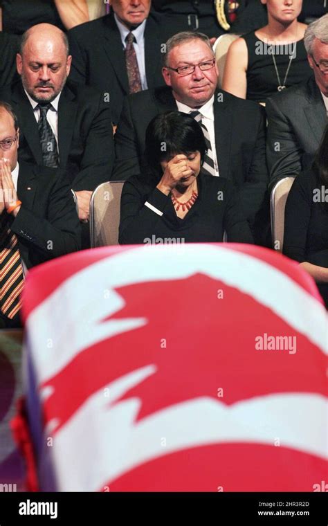 Olivia Chow sits behind her husband's coffin during the state funeral ...