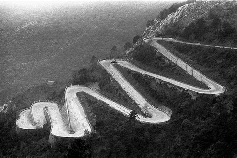 Road ascends to the Col de Braus using hairpin bends in the French Alps ...