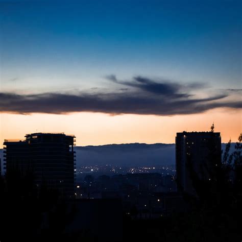 Premium Photo | A city skyline with a few buildings and a sky with clouds