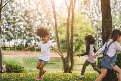 Cute african american little girl playing outdoor - Black people kid and friend happy. Stock ...