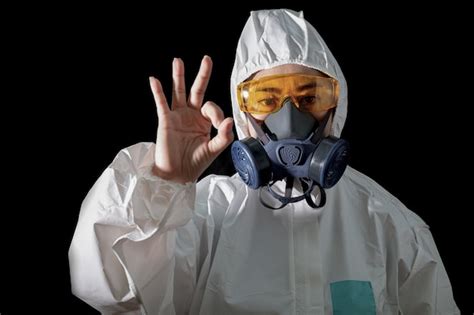 Premium Photo | Woman in a chemical protective clothing and antigas ...