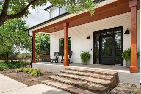 Check out this modern farmhouse-style front porch with natural stone steps on HGTV.com. | Modern ...