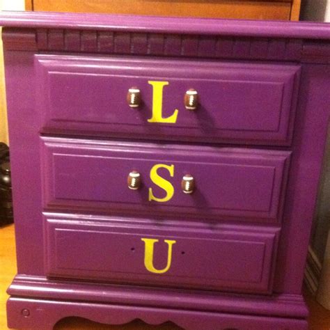 a purple dresser with the letters u and l painted on it's bottom drawer
