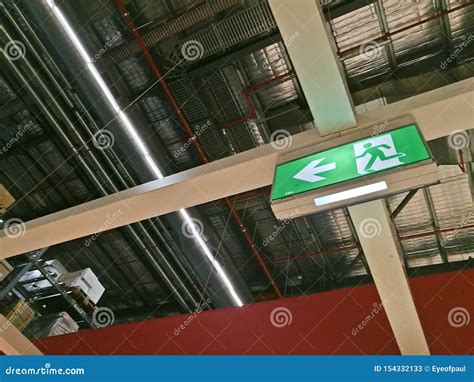 Emergency Exit Route Sign on Top of Factory Warehouse Stock Image ...