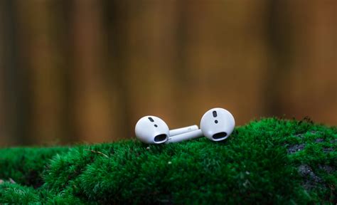 Shallow Focus Photography of White Airpods on Green Surface · Free ...