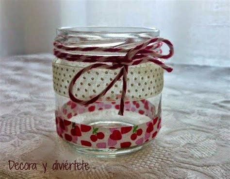 a glass jar with some red and white ribbon on top of the jar is sitting on a lace tablecloth