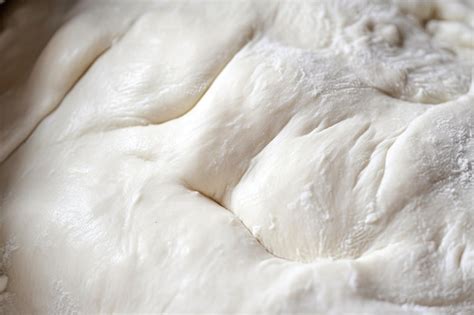 Premium AI Image | Closeup of pizza dough showing its stretchy and ...