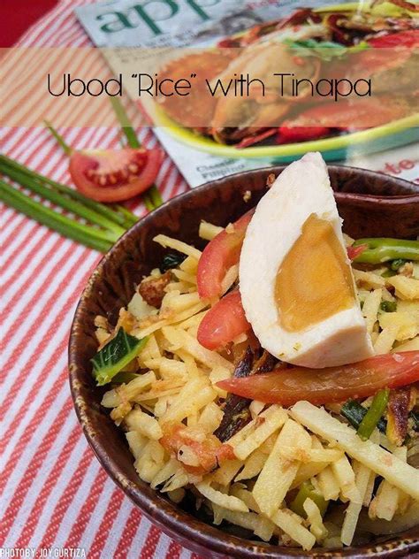 a brown bowl filled with food on top of a red and white checkered table cloth