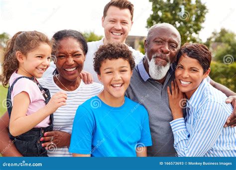 Portrait of Smiling Multi-Generation Mixed Race Family in Garden at ...