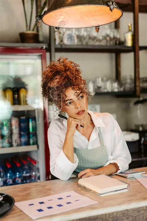 Coffee shop owner thinking while calculating her expenses – Jacob Lund Photography Store ...