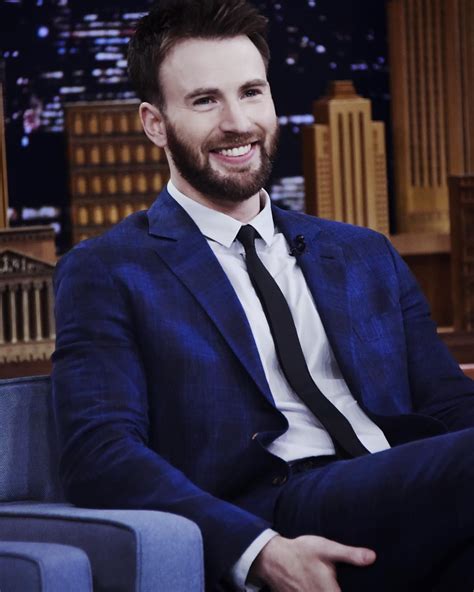 a man in a suit and tie sitting down