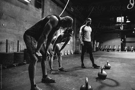 "Group Of Young Mixed Race People Working Out In Gritty Gym - Post Kettlebells" by Stocksy ...