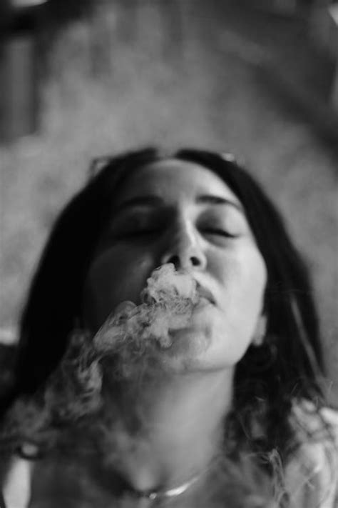 Portrait of a Woman Smoking a Cigarette in Black and White · Free Stock Photo