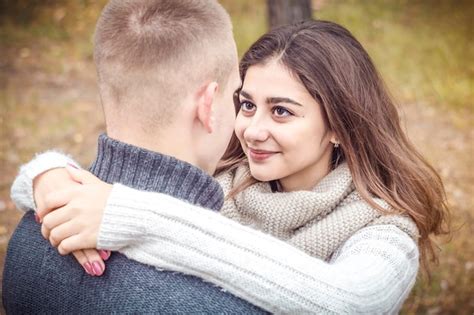 Premium Photo | A beautiful girl hugs her boyfriend. happy young people. the concept of love