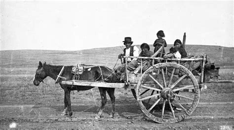 [Metis family travelling in a Red River Cart]. | Montana History Portal