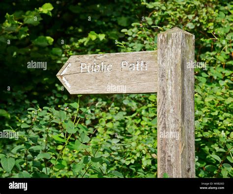 Weathered wooden sign post pointing to Public Path Stock Photo - Alamy