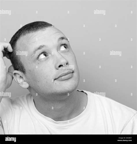 Portrait of confused man against green background looking up Stock Photo - Alamy
