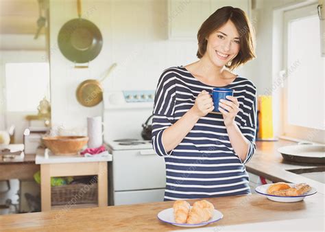 Portrait woman drinking coffee in kitchen - Stock Image - F015/4773 ...