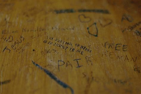 "Graffiti Scratched Into School Desk Top" by Stocksy Contributor "Margaret Vincent" - Stocksy