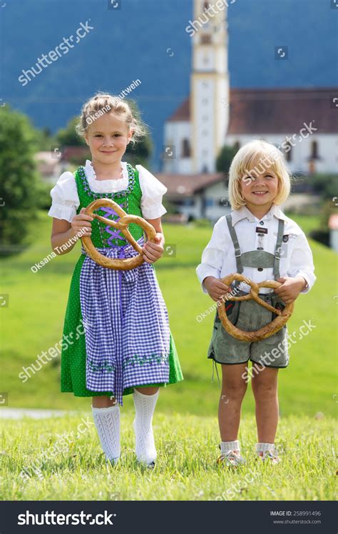 Two Little Children In Traditional German Bavarian Clothes Hold Pretzel In The Hands Stock Photo ...