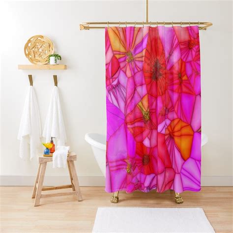 a shower curtain with pink and orange flowers on it in a white room next to a bath tub