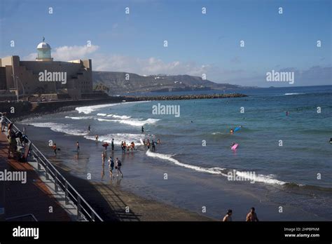 Young people and children surfing in Las Canteras beach in Las Palmas ...