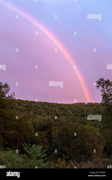 rainbow over a mountain Stock Photo - Alamy