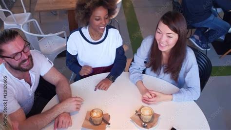 friends giving high five to each other in cafe Stock Video | Adobe Stock