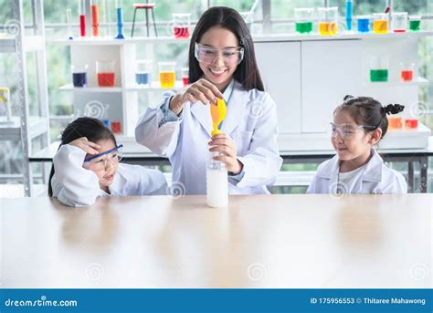 Asian Female Teacher Scientific Experiments are Being Performed for ...