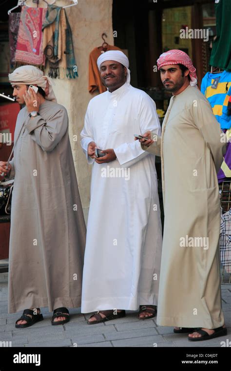 Qatar, Doha, young men, traditional dress, mobile phones Stock Photo ...