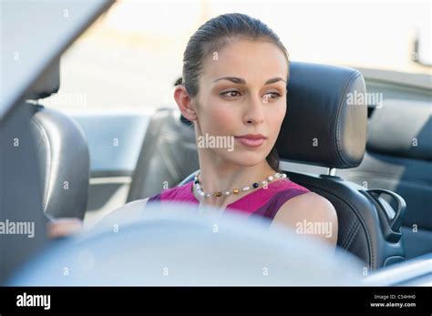 Young woman driving a convertible car Stock Photo - Alamy