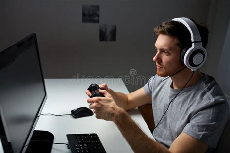 Man in Headset Playing Computer Video Game at Home Stock Photo - Image of headphones ...