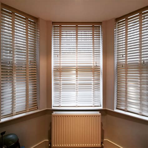 Wooden venetian blinds with fabric tapes for bay window in Chelsea, London #woodblinds # ...