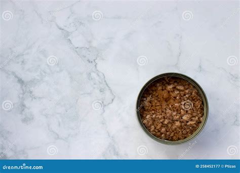 Open Tin Can with Chopped Tuna in Oil on White Marble Kitchen Table ...