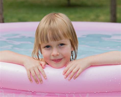 Smiling Little Girl in Inflatable Pool Stock Photo - Image of cheerful, playing: 58701146