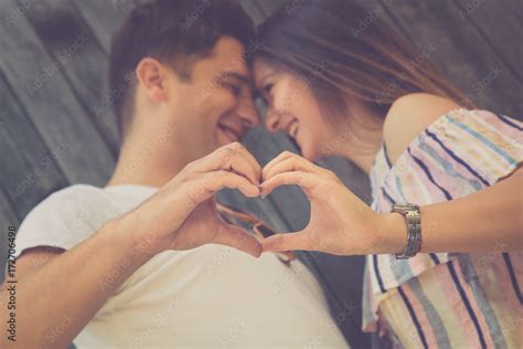 Young couple holding hands in shape of heart Stock Photo | Adobe Stock