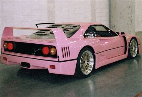 a pink sports car parked in a garage