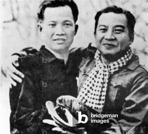 Image of Cambodia: Wearing Khmer Rouge garb, Norodom Sihanouk embraces Khieu Samphan