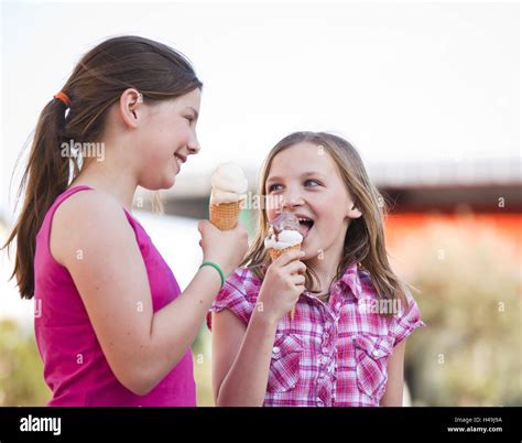 two friends eating ice cream Stock Photo - Alamy