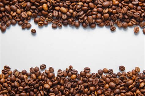 Free Photo | Coffee beans top view on a white background space for text