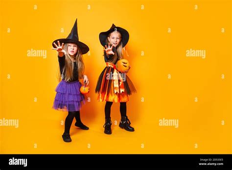 Happy little girls laughing and making scary faces during Halloween ...