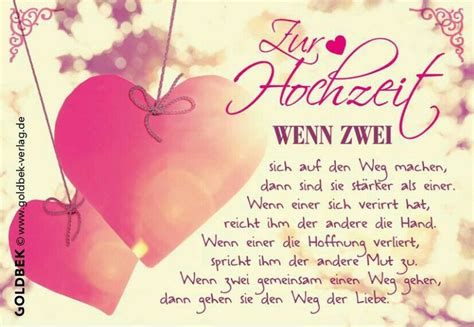 two pink hearts hanging from strings with words written in german