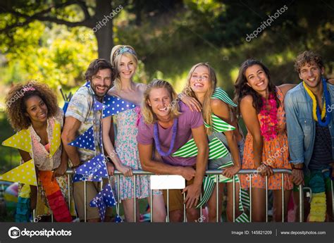 Group of friends standing together in park Stock Photo by ©Wavebreakmedia 145821209