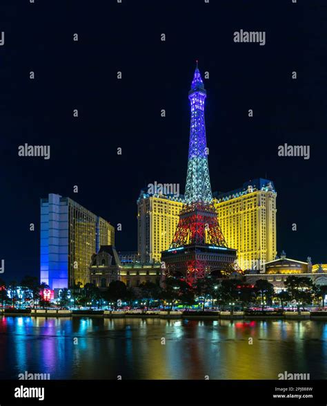 A picture of the Paris Las Vegas at night, with the Eiffel Tower decorated with the colors of ...