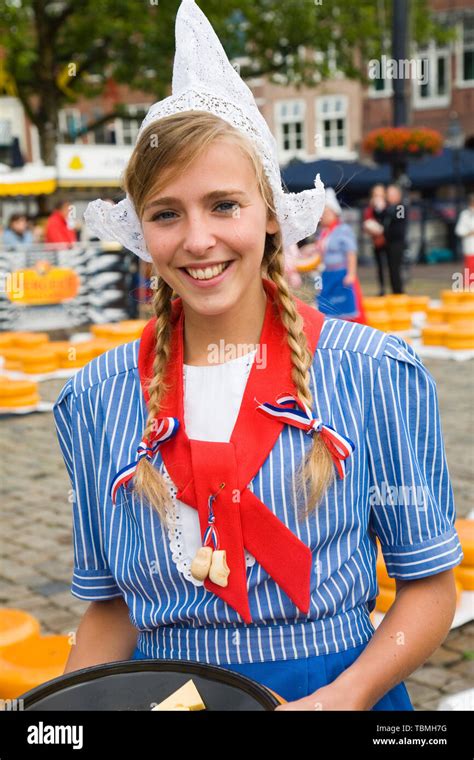 Pretty smiling girl in traditional Dutch costume, Gouda cheese market ...