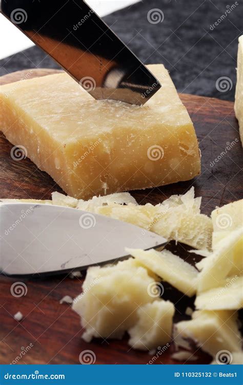 An Aged Authentic Parmigiano Reggiano Parmesan Cheese with Cheese Knife. Stock Photo - Image of ...