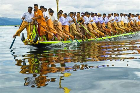 Inther ( people from Inlay lake in Myanmar) are rowing the long boat with their legs ...