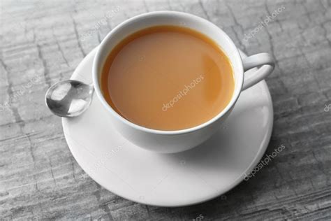 Cup of tea with milk Stock Photo by ©belchonock 110564612